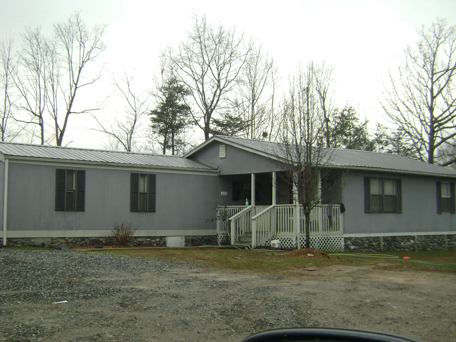 Metal roof over a manufactured home with a covered front porch in Bowersville