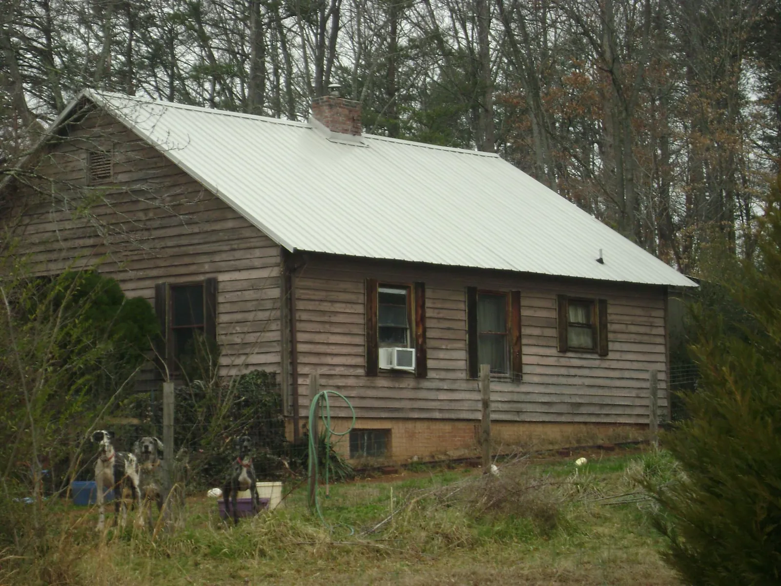 White metal roof on an old wood sided farmhouse, from a Metal Roof Installation job in Bowersville